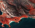 Sentinel-2 image shows burnscars near Cape Town, South Africa. The false-colour image shows burnt areas in dark greys and browns, and areas covered with vegetation in red.Image: ESA/ CC BY-SA 3.0 IGO.