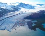 The terminus of Bear Glacier occurs in iceberg filled freshwater lagoon. Kenai Fjords National Park, Alaska. Image: NASA.