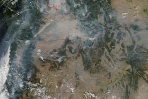 Satellite image of active wildfires across Western U.S., outlined in red (Image: NASA)