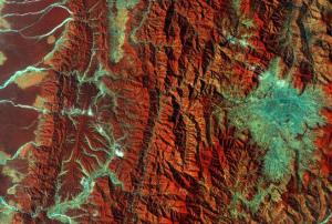 This image captured by the Copernicus Sentinel-2A satellite on 28 December 2015. It demonstrates Nepal’s varied terrain from the mountains to the north (left side) to the plains in the south (right side). Vegetation appears red in this false-colour image, while waterways and buildings appear light green and blue. Image: ESA.