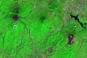 Image captured by Sentinel-2 on February 8 2021 of the Fuego volcano (left), Pacaya volcano (right), Guatemala City (upper right), with volcano lava visible in red. Image: Sentinel Hub, ESA.