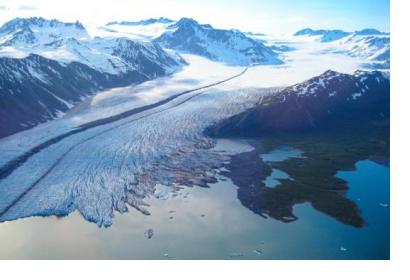 The terminus of Bear Glacier occurs in iceberg filled freshwater lagoon. Kenai Fjords National Park, Alaska. Image: NASA.